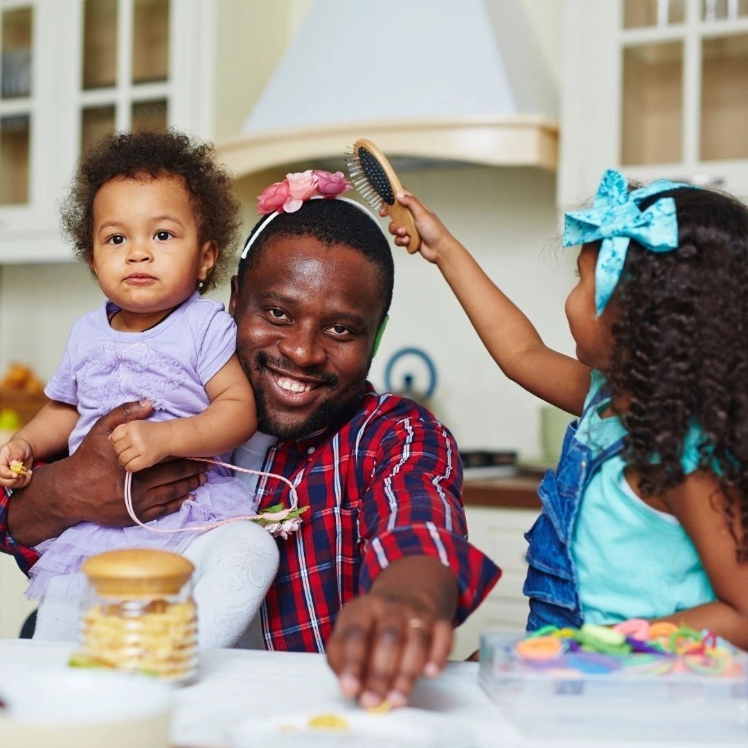 Father with two daughters in the kitchen